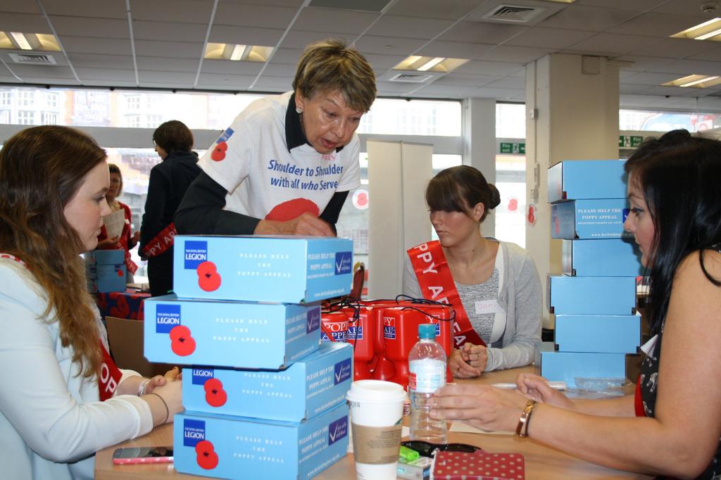A volunteer coordinator works with the AvePoint team to assemble and pack pins.