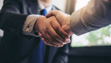 Two business men shaking hands during a meeting to sign agreement and picture id886031704
