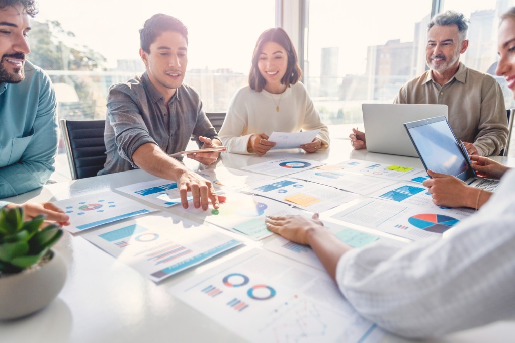 Multi racial diverse group of people working with paperwork on a picture id1367899893