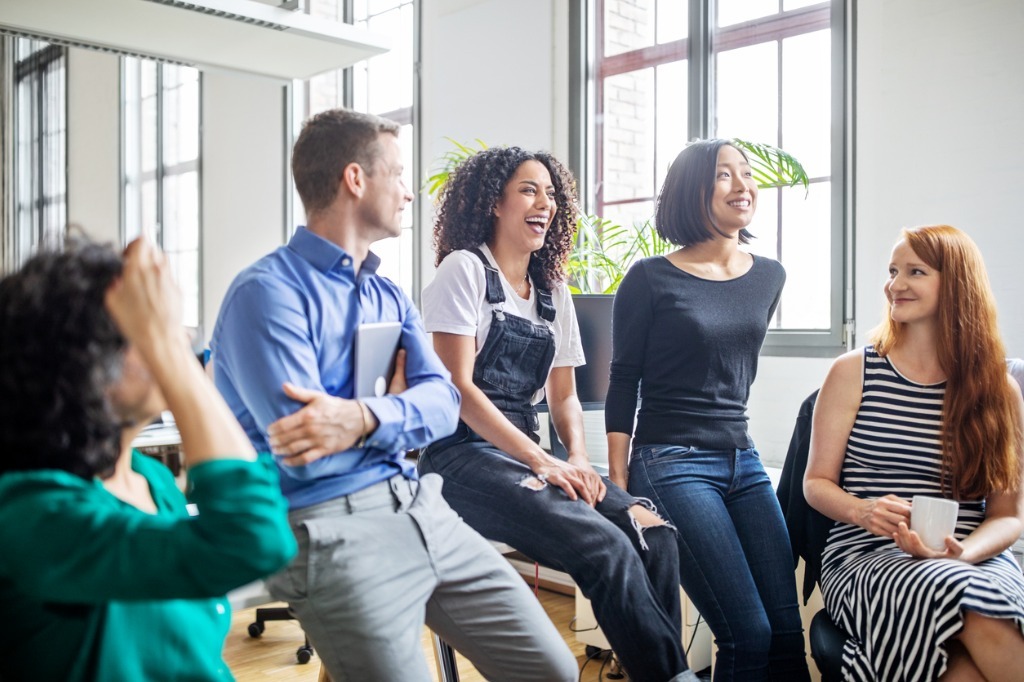 Professionals laughing in a meeting picture id1150572098