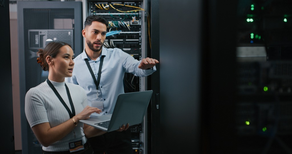 Shot of two colleagues working together in a server room picture id1332104905