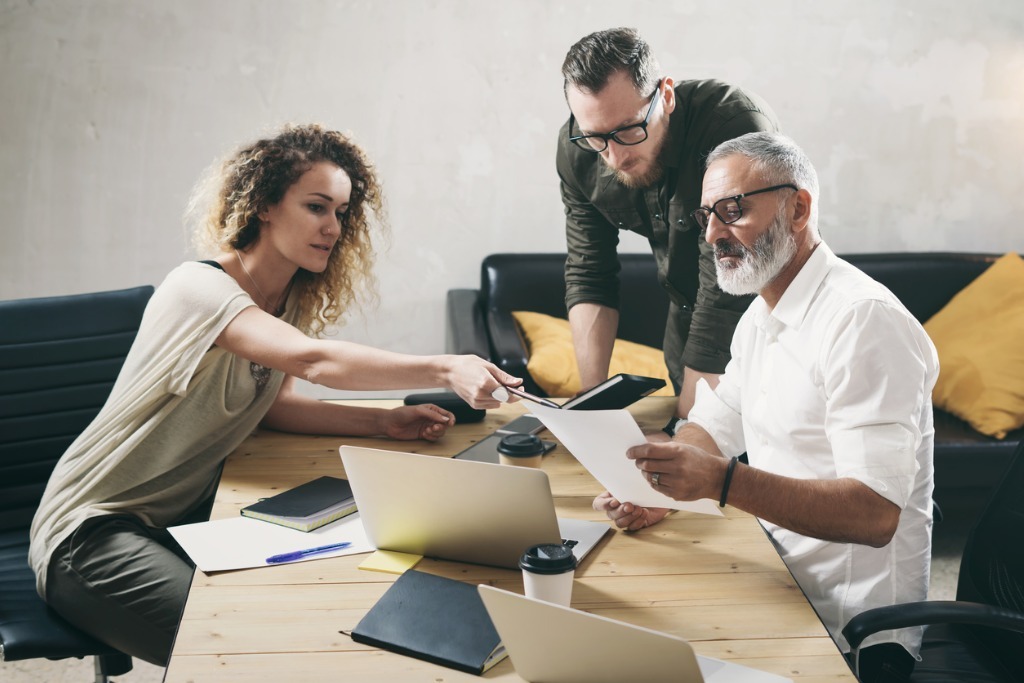 Young team of coworkers making great work discussion in modern man picture id1128279963