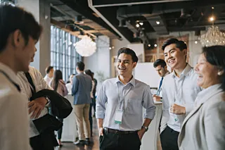 Diversify Asian seminar participants casual chat after successful conference event at lounge