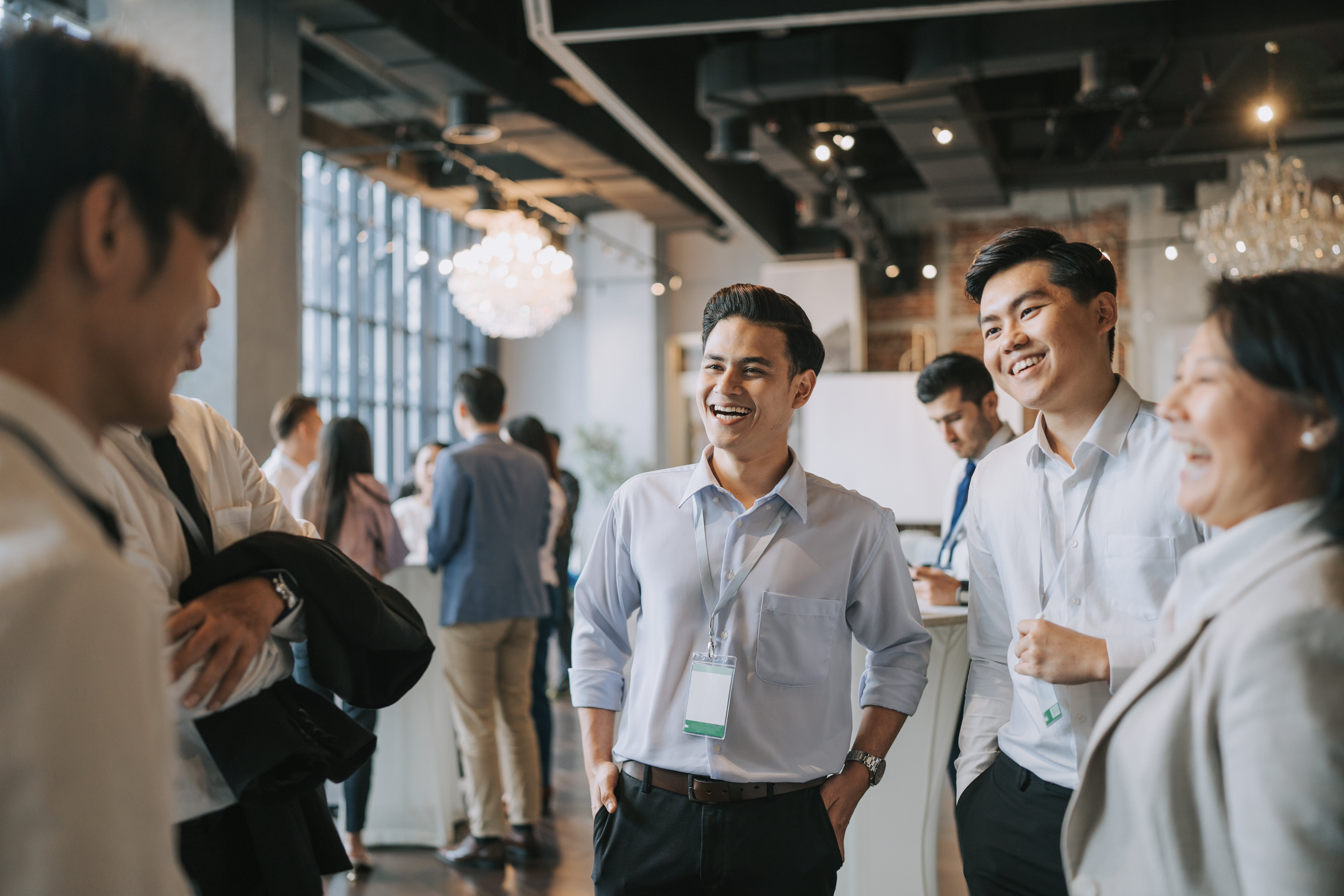 Diversify Asian seminar participants casual chat after successful conference event at lounge